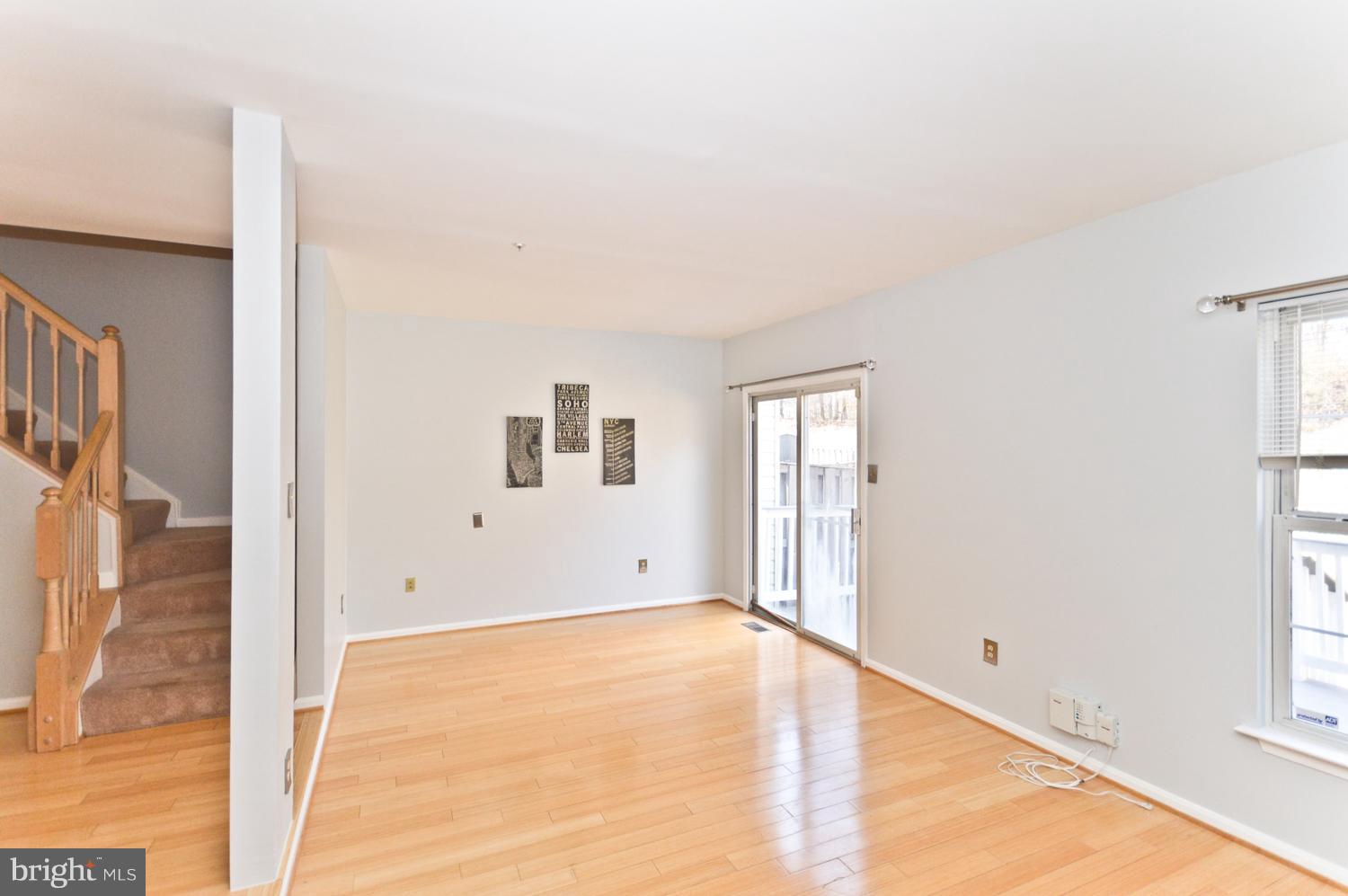 9923 Raintree Way Clinton, MD 20735 - Photo 12 of 30 a view of an empty room with wooden floor and a window
