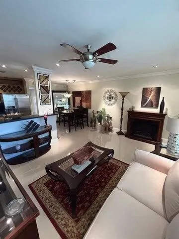 a living room with furniture and kitchen view