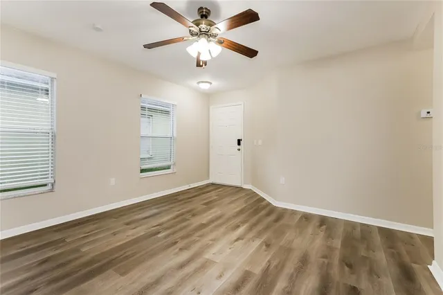wooden floor in an empty room with a window