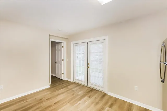 a view of an empty room and wooden floor