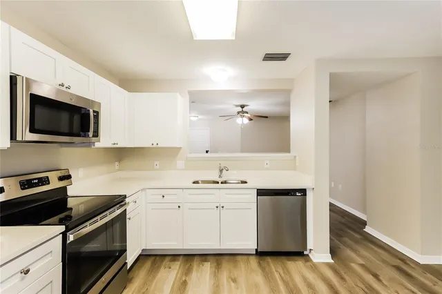 a kitchen with a sink stove and microwave