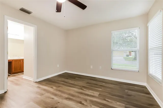 wooden floor in an empty room with a window