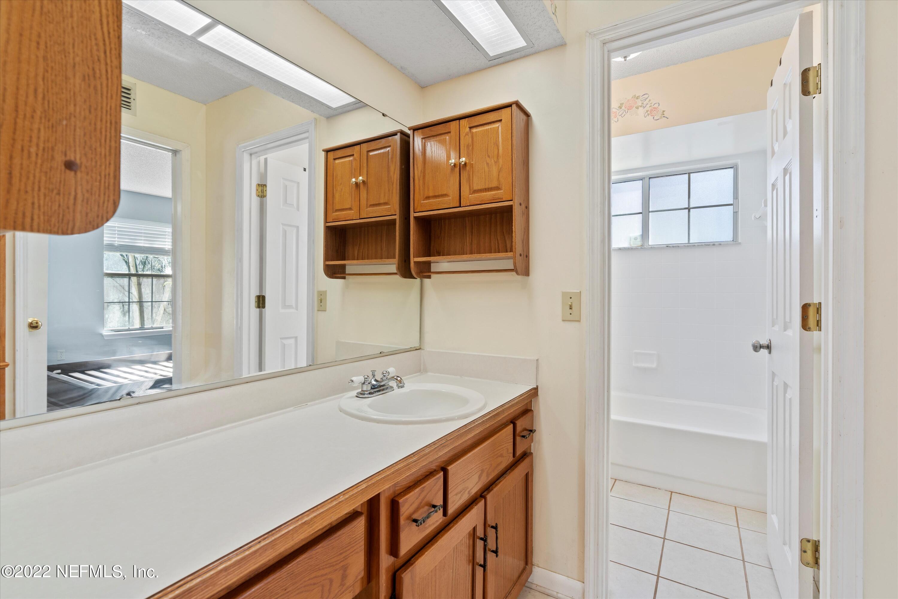10498 Rothbury Court Jacksonville, FL 32221 - Photo 16 of 35 a bathroom with a sink a vanity and a mirror
