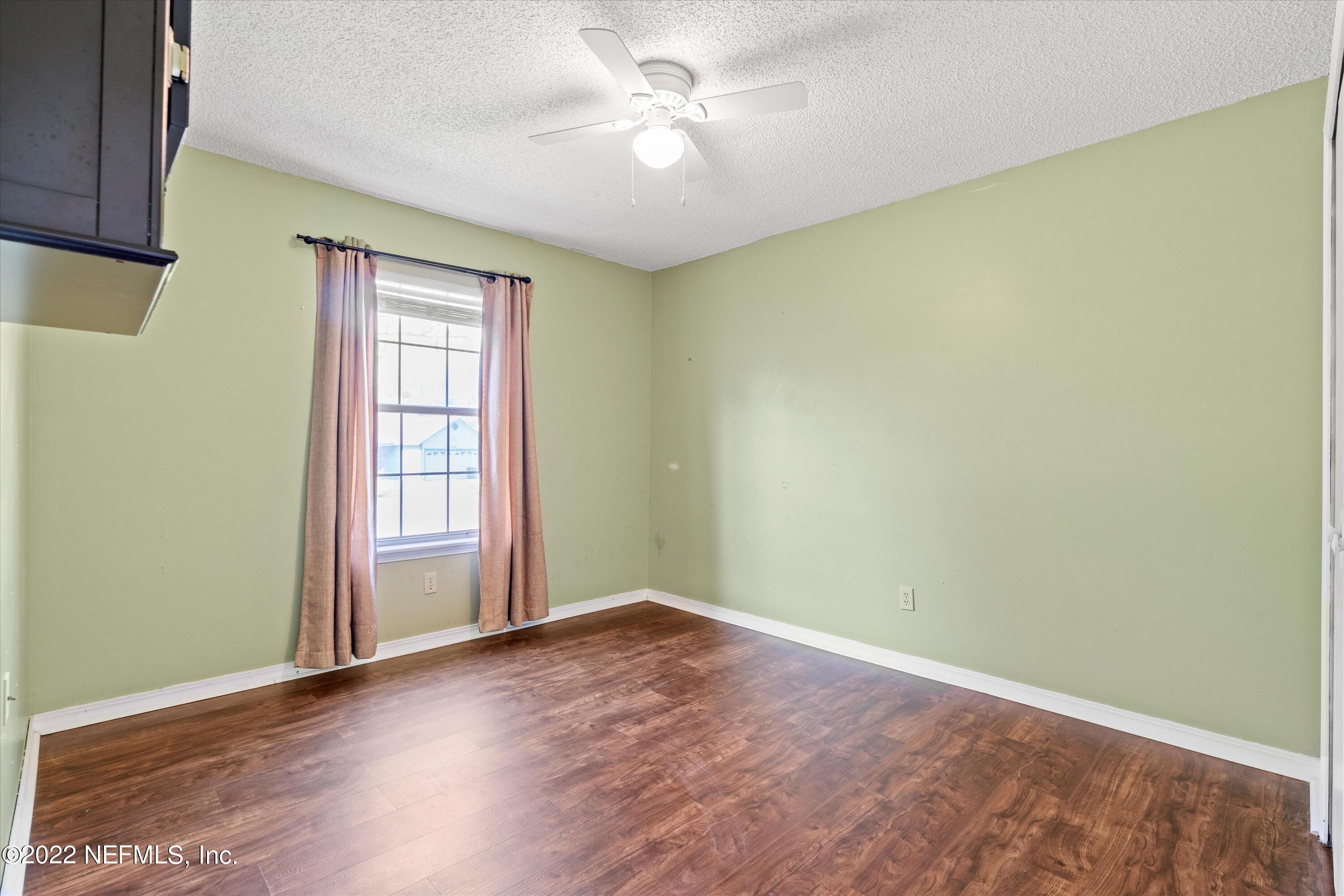 10498 Rothbury Court Jacksonville, FL 32221 - Photo 19 of 35 an empty room with windows and ceiling fan