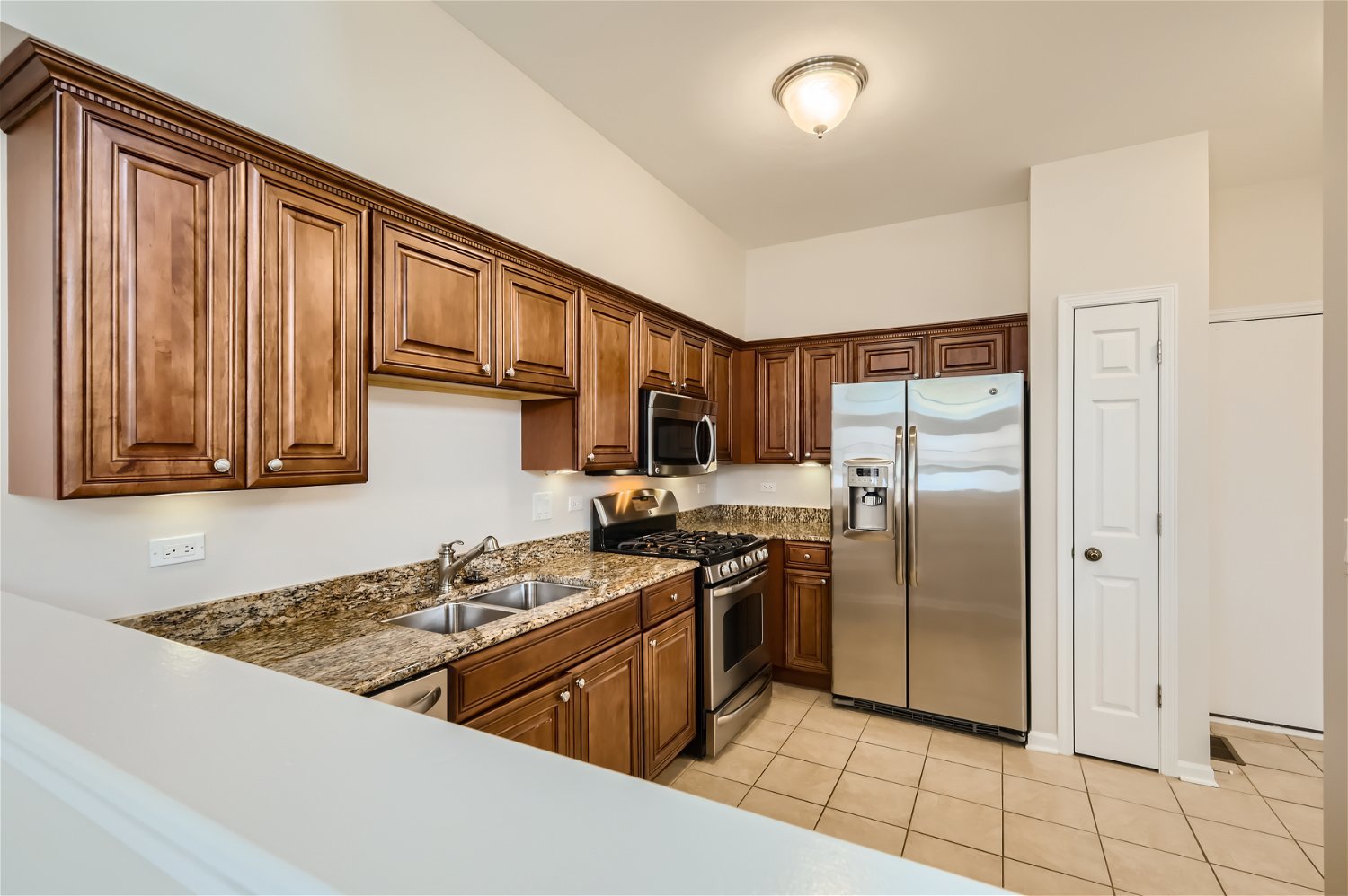 1 Charlotte Circle Elmhurst, IL 60126 - Photo 3 of 11 a kitchen with stainless steel appliances granite countertop a refrigerator stove and sink