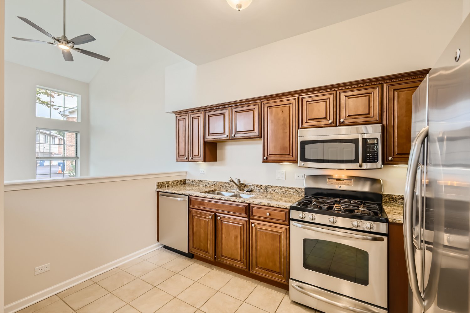 1 Charlotte Circle Elmhurst, IL 60126 - Photo 4 of 11 a kitchen with stainless steel appliances granite countertop a stove a sink and a microwave