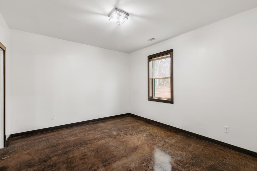 620 A Stiles Road Epworth, GA 30541 - Photo 13 of 21 an empty room with a window