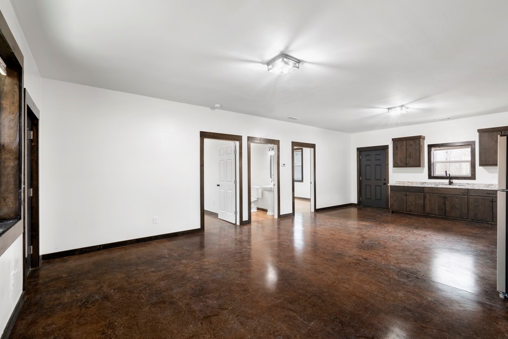 620 A Stiles Road Epworth, GA 30541 - Photo 19 of 21 a view of an empty room with window and wooden floor