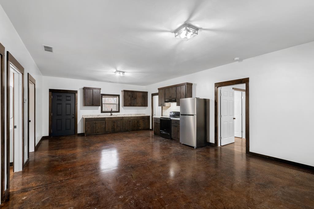 620 A Stiles Road Epworth, GA 30541 - Photo 3 of 21 a view of a kitchen with refrigerator and microwave