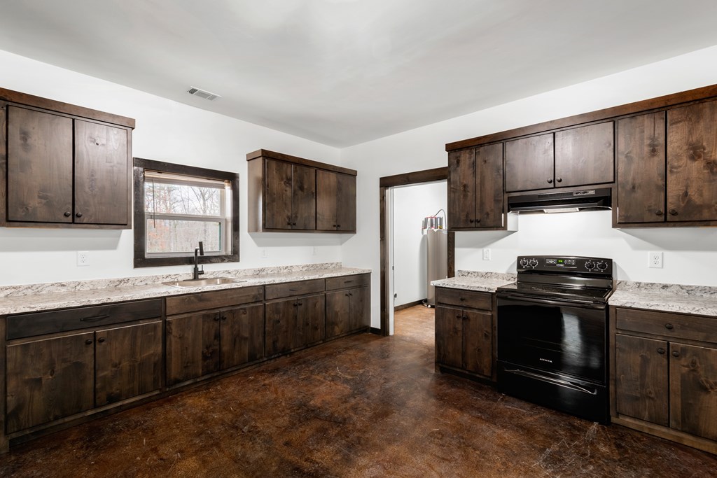 620 A Stiles Road Epworth, GA 30541 - Photo 4 of 21 a kitchen with stainless steel appliances granite countertop a stove a sink and a microwave