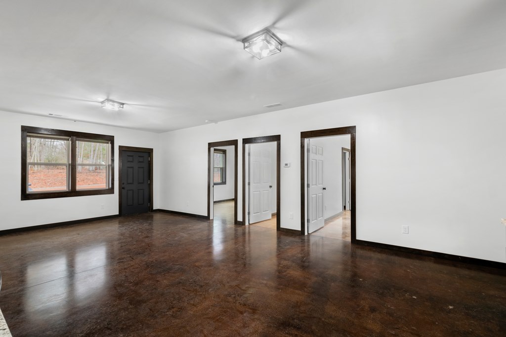 620 A Stiles Road Epworth, GA 30541 - Photo 7 of 21 a view of an empty room with a window and wooden floor