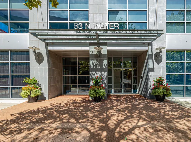 a view of a house with potted plants