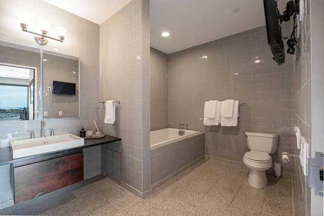 a bathroom with a sink a toilet and bathtub