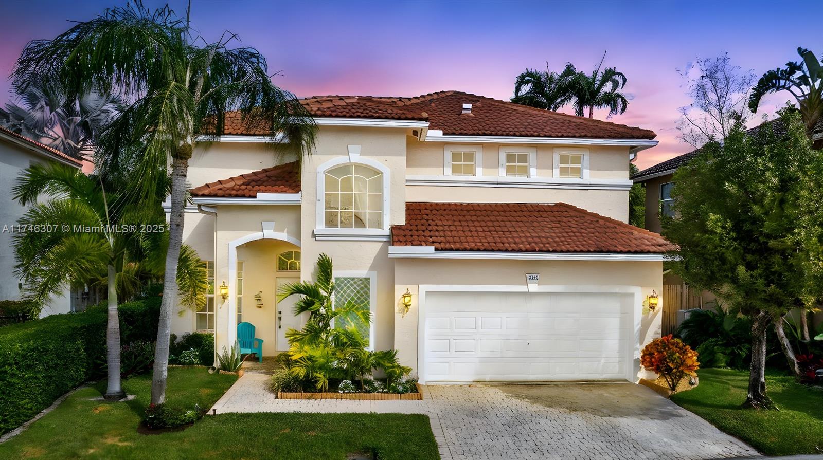 a front view of a house with a garden and plants