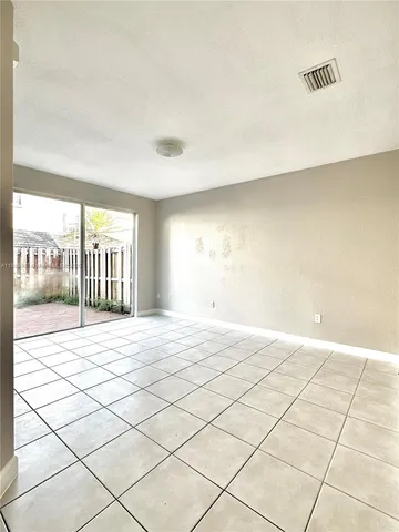 a view of an empty room and a window