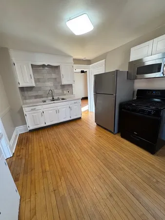 a kitchen with stainless steel appliances a refrigerator and a stove top oven