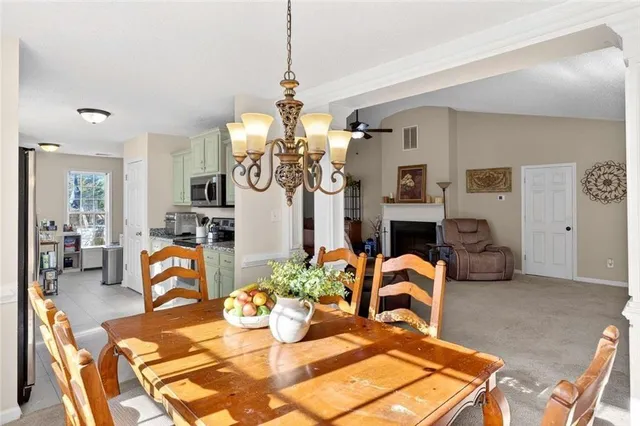 a living room with fireplace furniture and a chandelier
