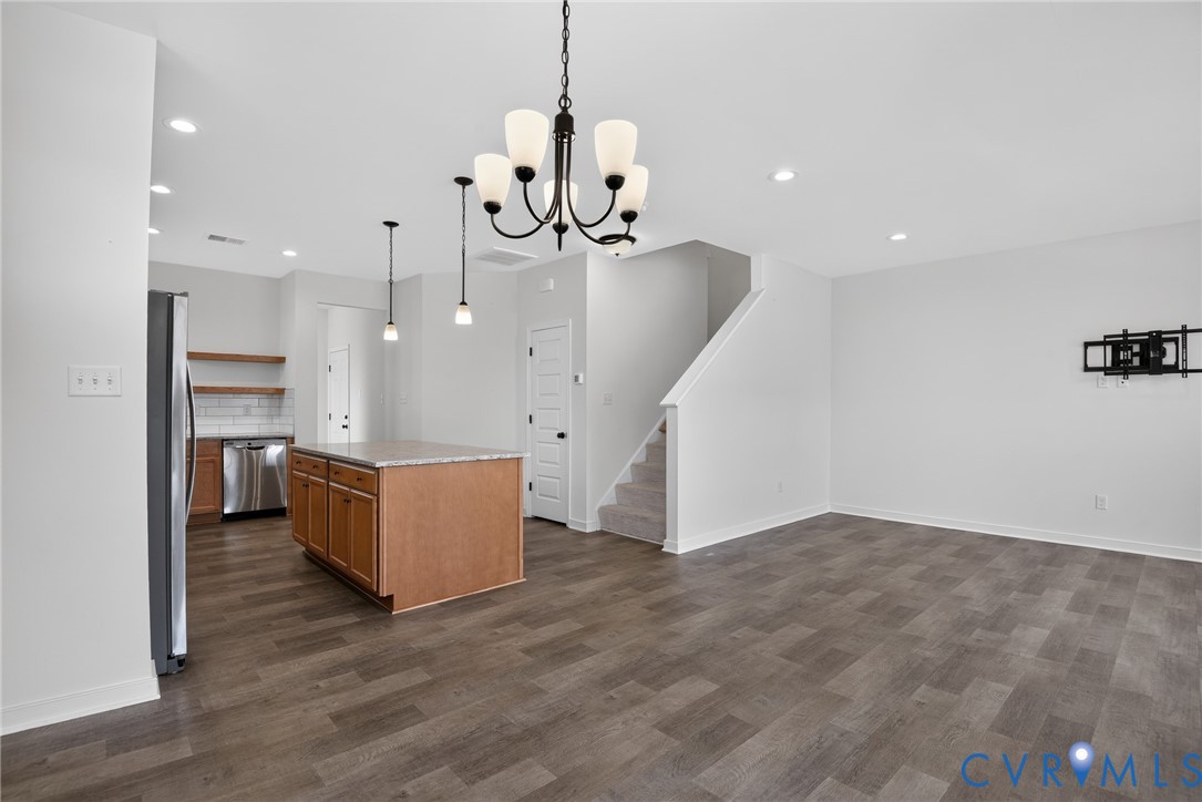 7825 Old Guild Road Richmond, VA 23237 - Photo 9 of 35 Open-concept living space featuring wood-finish fl