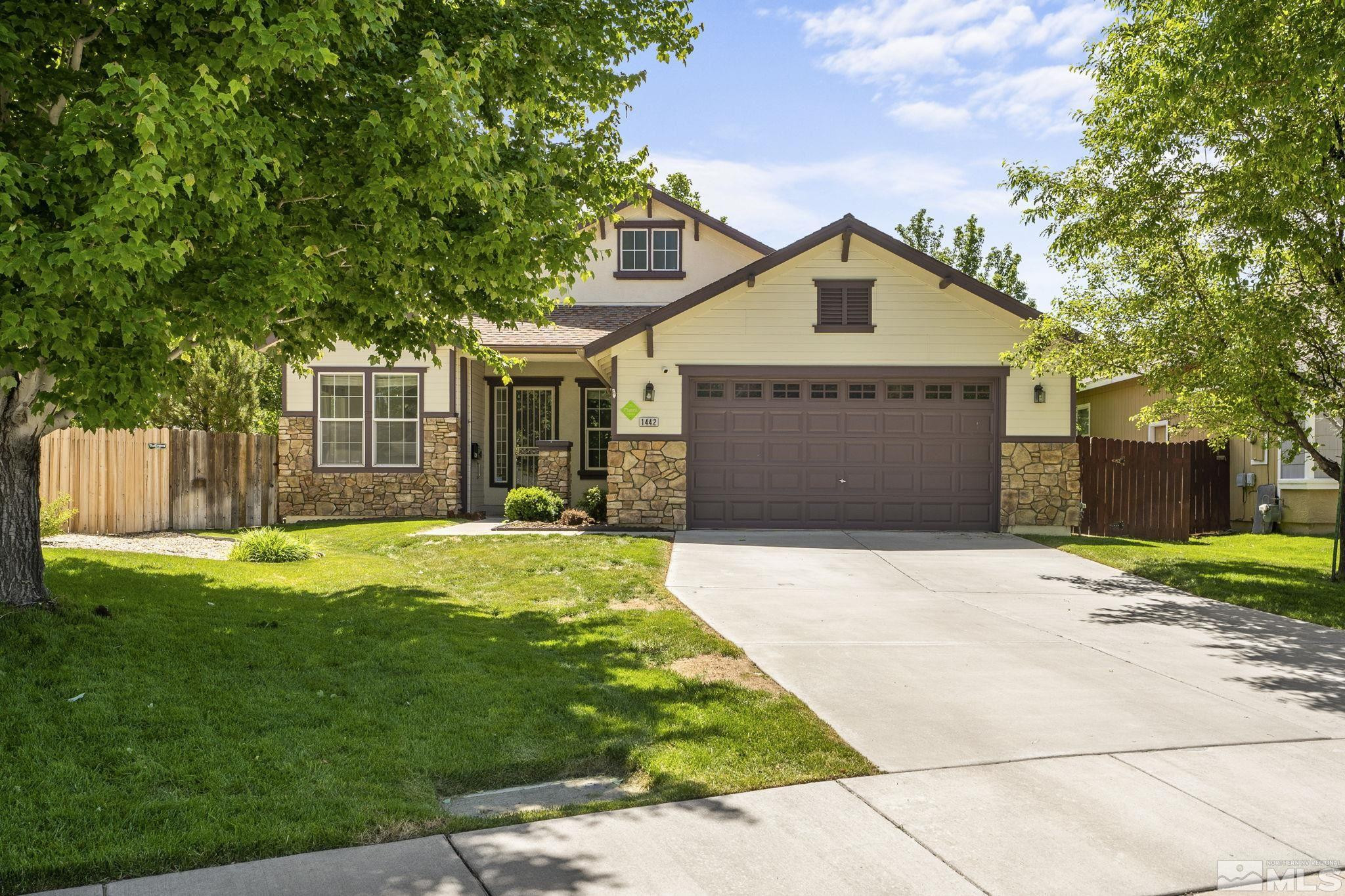 1442 Wessex Circle Reno, NV 89503 - Photo 1 of 32 a front view of a house with a yard and garage