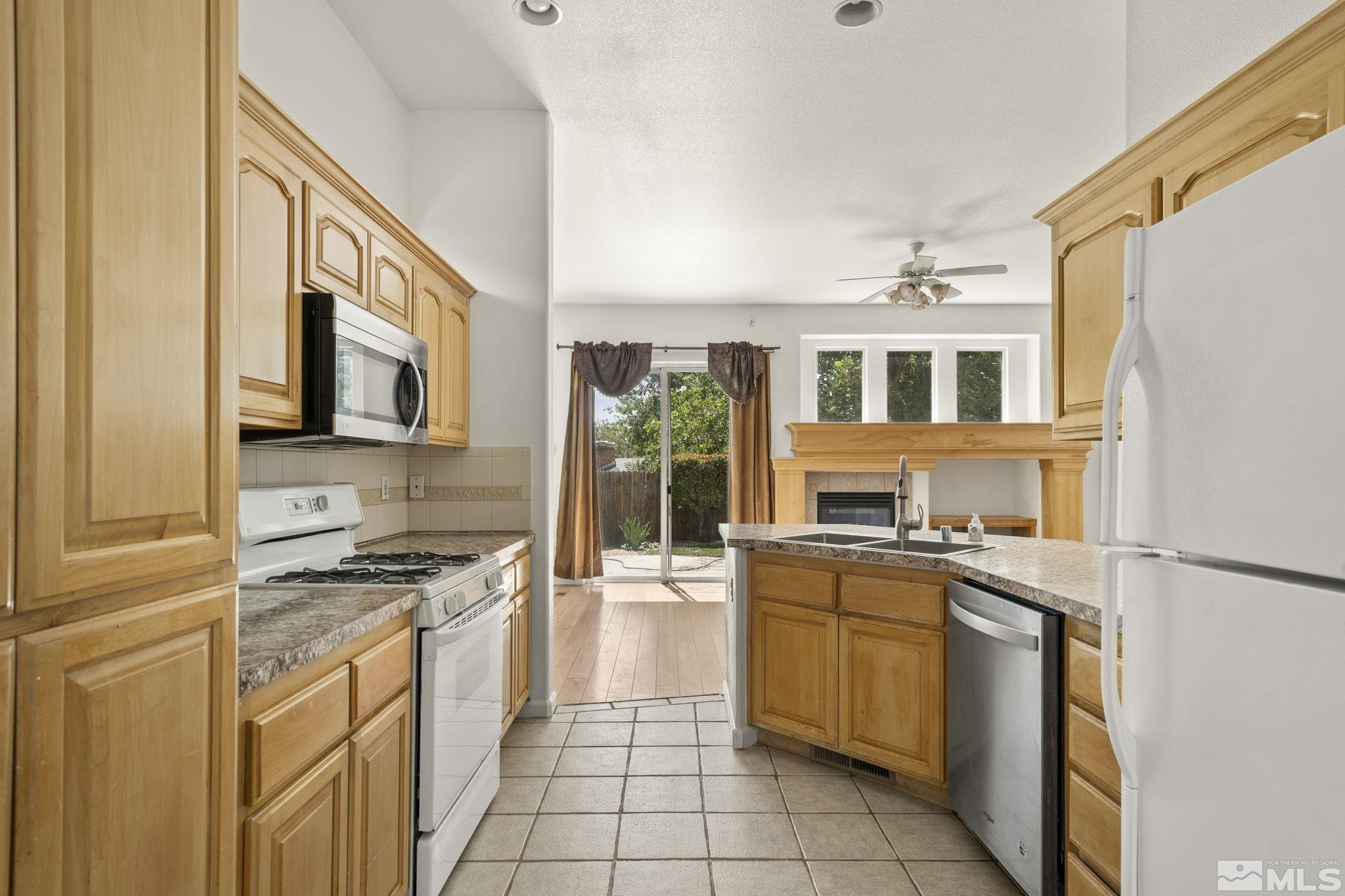 1442 Wessex Circle Reno, NV 89503 - Photo 12 of 32 a kitchen with a stove a sink and a refrigerator