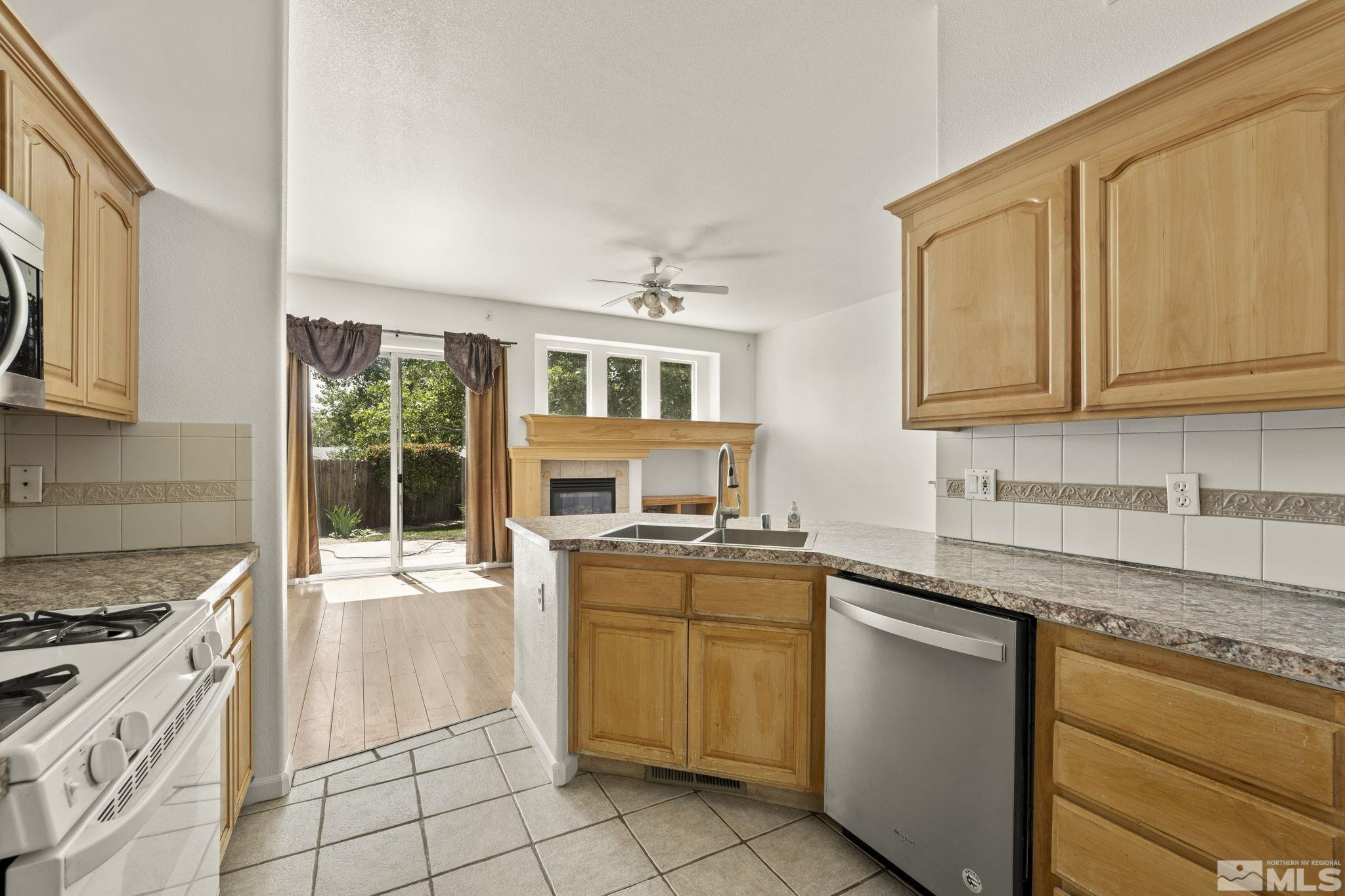 1442 Wessex Circle Reno, NV 89503 - Photo 13 of 32 a kitchen with stainless steel appliances granite countertop a stove and a sink