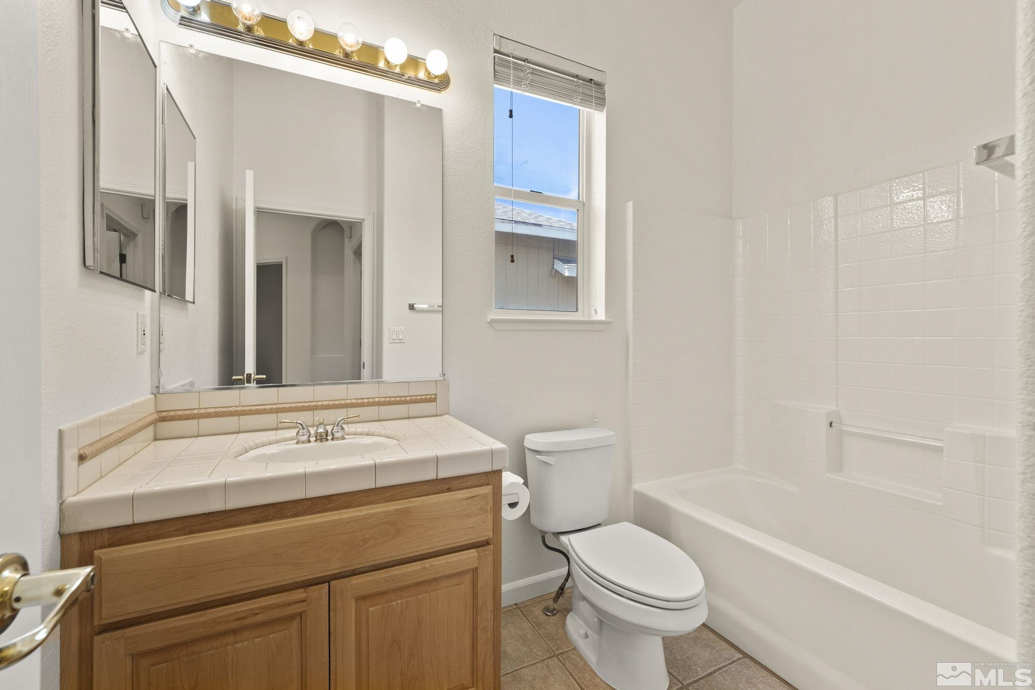1442 Wessex Circle Reno, NV 89503 - Photo 24 of 32 a bathroom with a sink toilet vanity and shower