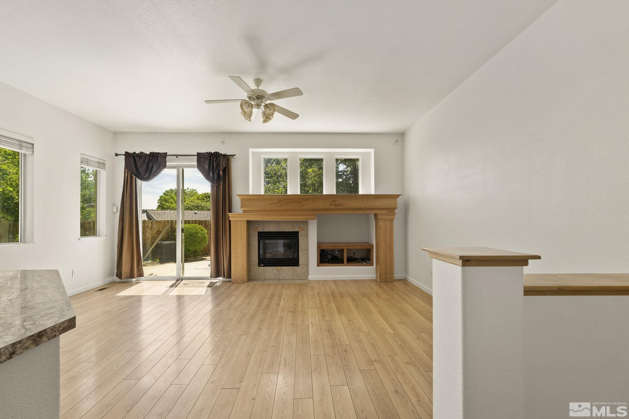 1442 Wessex Circle Reno, NV 89503 - Photo 5 of 32 a view of a livingroom with wooden floor and a fireplace