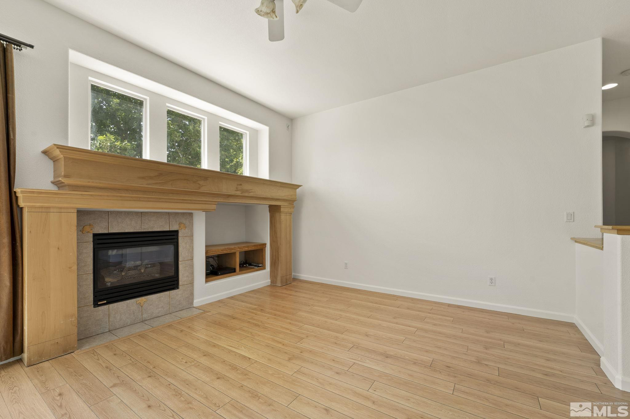 1442 Wessex Circle Reno, NV 89503 - Photo 6 of 32 a view of empty room with wooden floor and fireplace