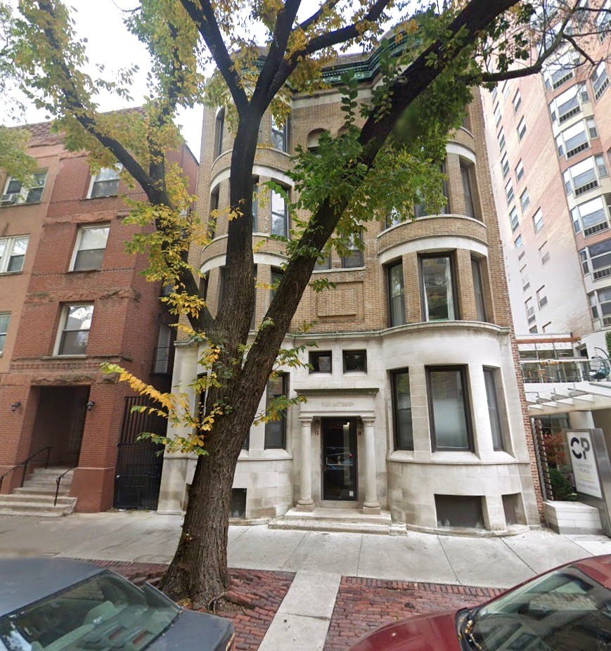 a front view of a residential apartment building with a yard