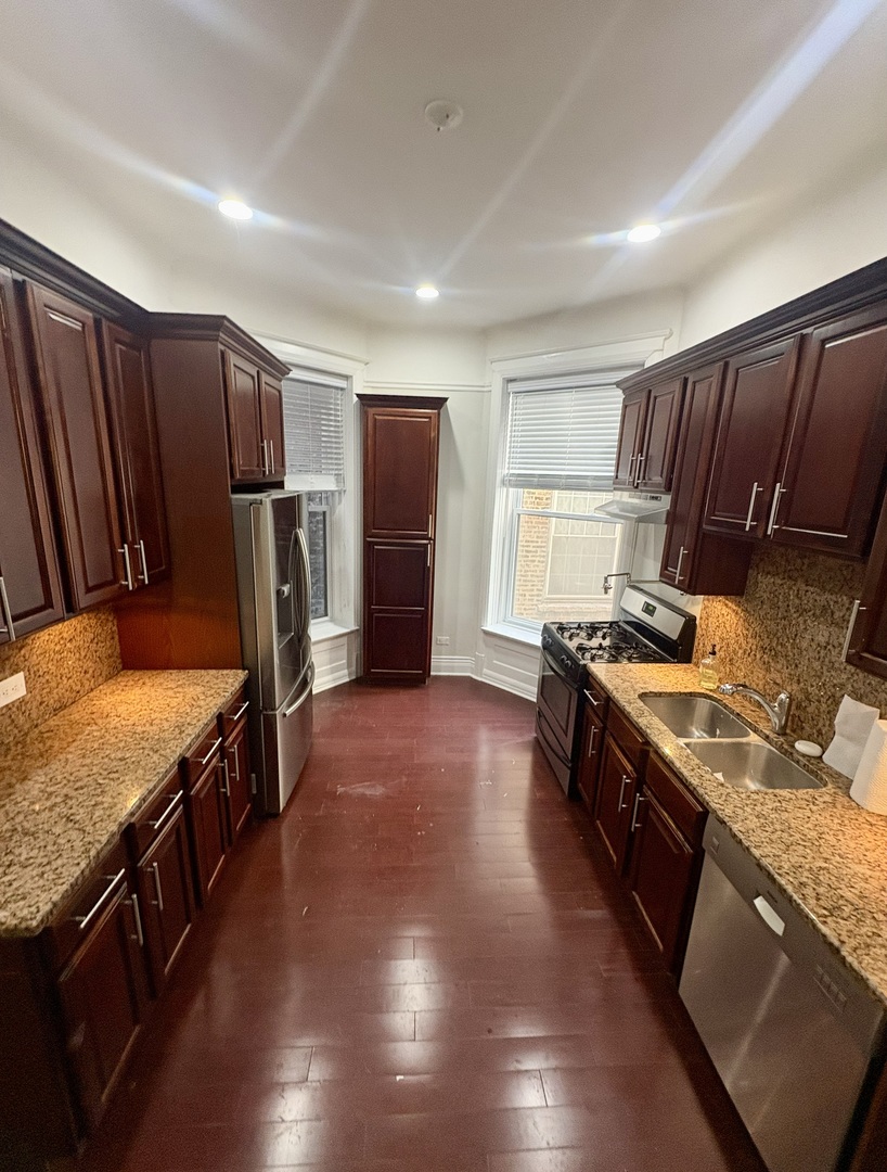 12 West Chestnut Street, Unit 3 Chicago, IL 60610 - Photo 11 of 20 a kitchen with stainless steel appliances granite countertop a stove a refrigerator a sink and dishwasher