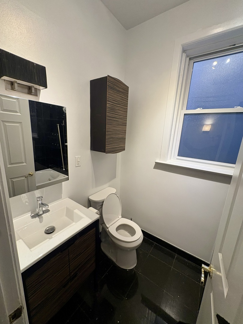 12 West Chestnut Street, Unit 3 Chicago, IL 60610 - Photo 13 of 20 a bathroom with a toilet sink and mirror