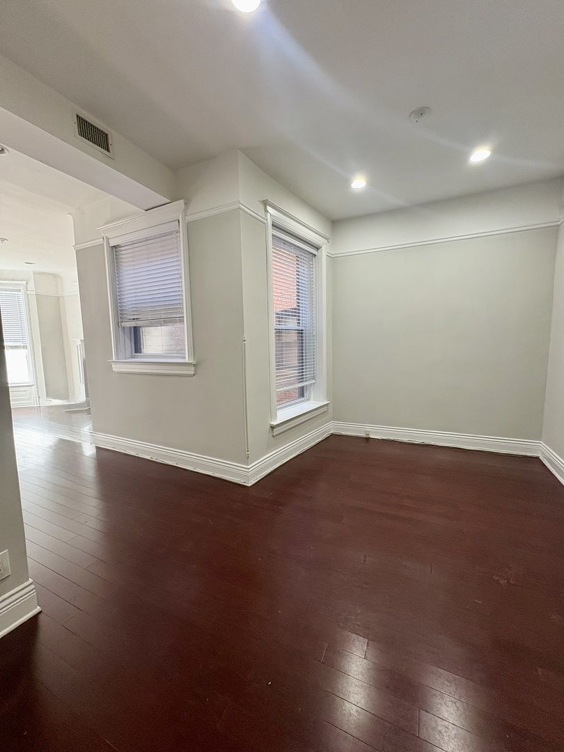 12 West Chestnut Street, Unit 3 Chicago, IL 60610 - Photo 15 of 20 an empty room with wooden floor and windows
