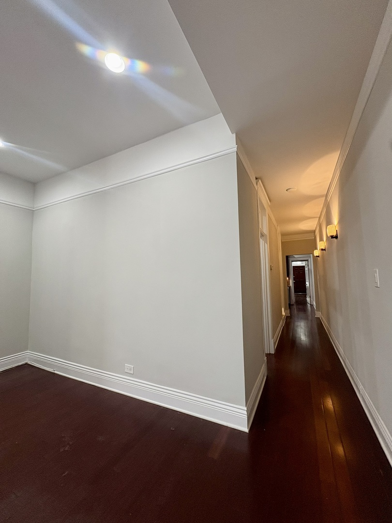 12 West Chestnut Street, Unit 3 Chicago, IL 60610 - Photo 7 of 20 a view of a hallway with wooden floor