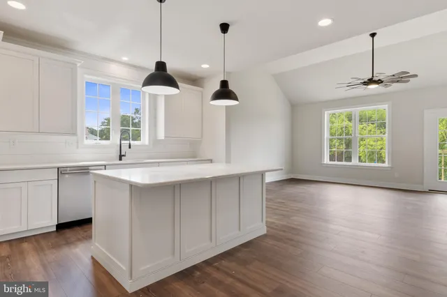 a kitchen with kitchen island a sink stainless steel appliances and window
