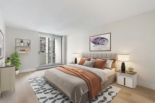 a bedroom with a large bed and a window