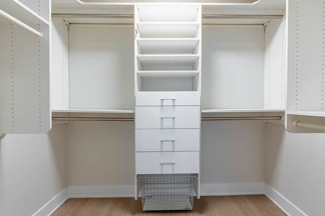 a view of walk in closet with empty racks