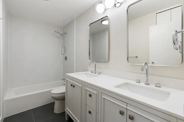 a bathroom with a sink toilet tub and shower