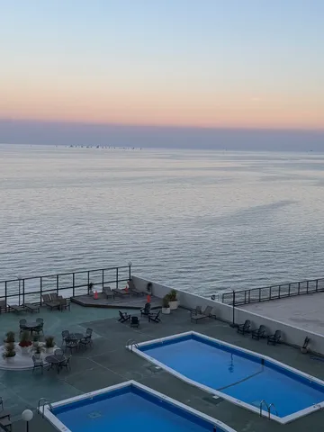 a view of a terrace with lawn chairs