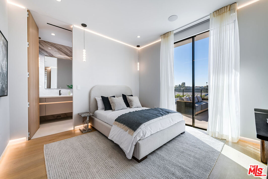 2078 Stradella Road Los Angeles, CA 90077 - Photo 19 of 37 a bedroom with a bed and a large mirror