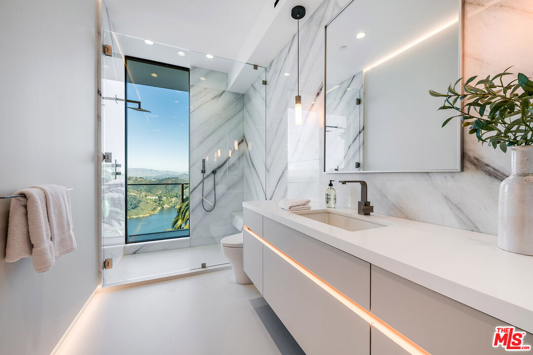 2078 Stradella Road Los Angeles, CA 90077 - Photo 20 of 37 a spacious bathroom with a double vanity sink and a shower