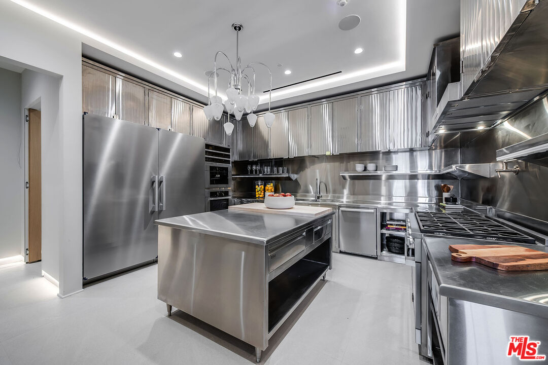 2078 Stradella Road Los Angeles, CA 90077 - Photo 26 of 37 a kitchen with stainless steel appliances granite countertop a stove and a refrigerator
