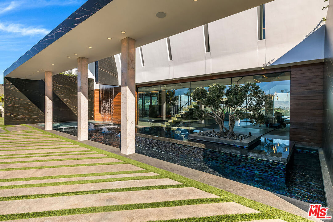 2078 Stradella Road Los Angeles, CA 90077 - Photo 3 of 37 a swimming pool with large windows