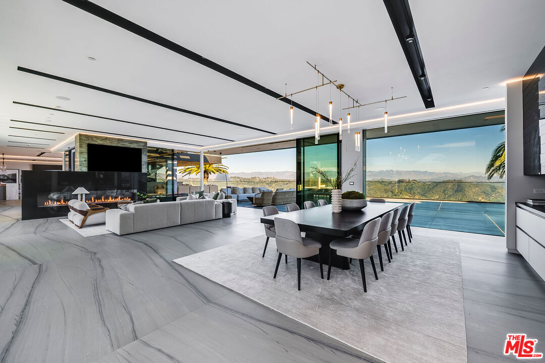 2078 Stradella Road Los Angeles, CA 90077 - Photo 8 of 37 a dining room with furniture and a floor to ceiling window