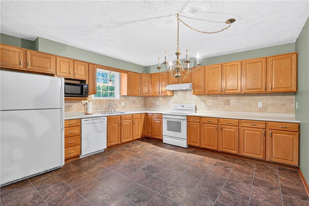 2902 Darlington Road, Unit 703 Beaver Falls, PA 15010 - Photo 13 of 37 a kitchen with stainless steel appliances granite countertop a refrigerator a sink dishwasher a stove with white cabinets