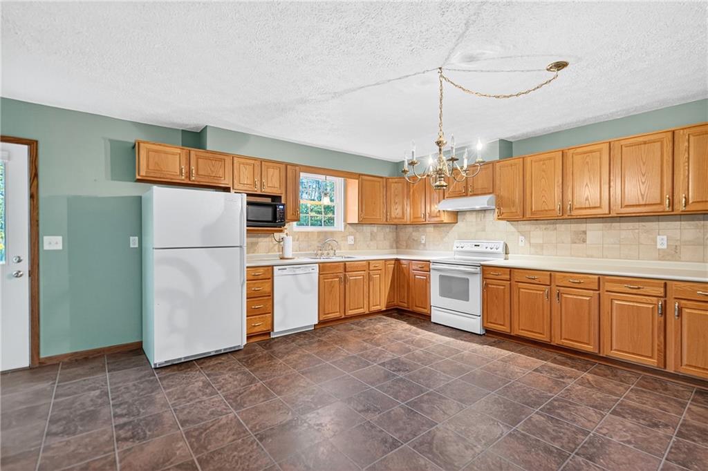 2902 Darlington Road, Unit 703 Beaver Falls, PA 15010 - Photo 14 of 37 a kitchen with refrigerator and cabinets
