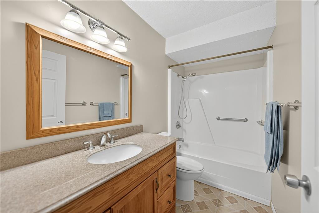 2902 Darlington Road, Unit 703 Beaver Falls, PA 15010 - Photo 23 of 37 a bathroom with a granite countertop sink toilet and shower