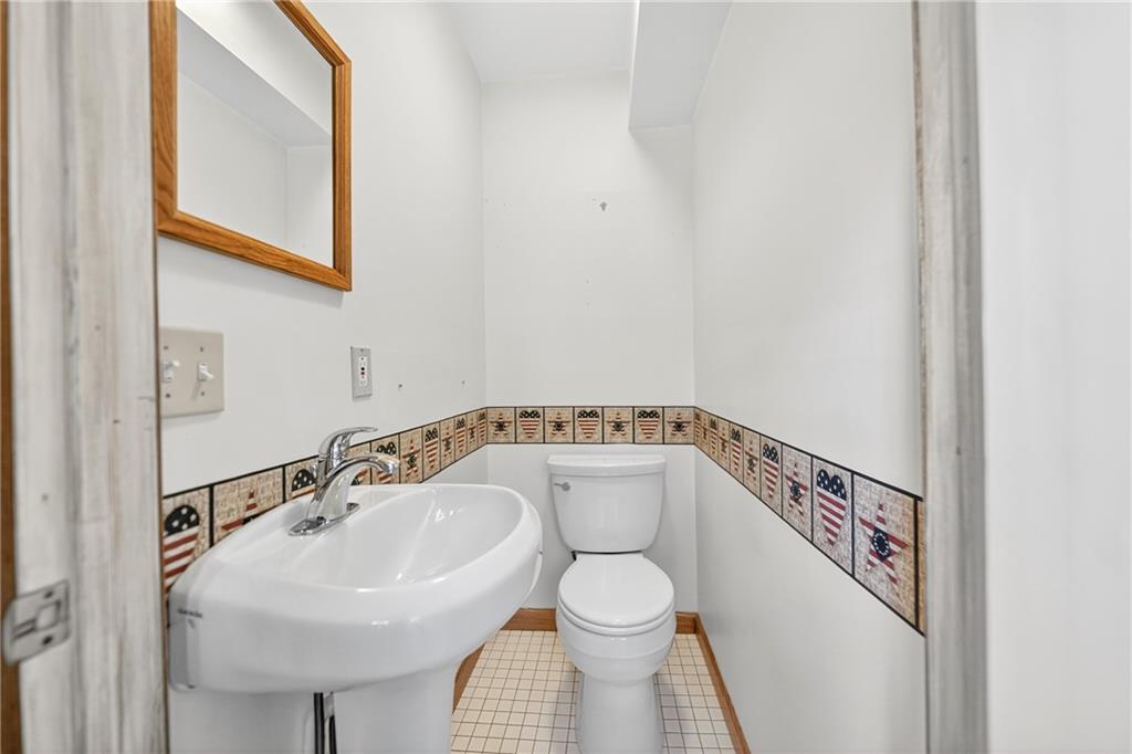 2902 Darlington Road, Unit 703 Beaver Falls, PA 15010 - Photo 36 of 37 a bathroom with a sink a mirror and toilet