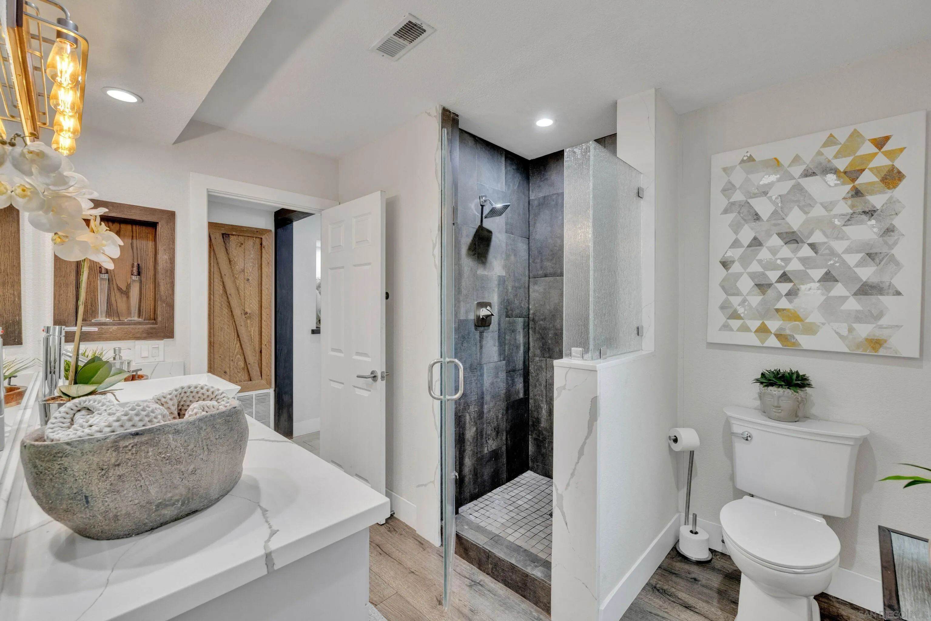 37389 Ave Chapala Temecula, CA 92592 - Photo 21 of 68 a bathroom with a granite countertop sink a toilet and shower