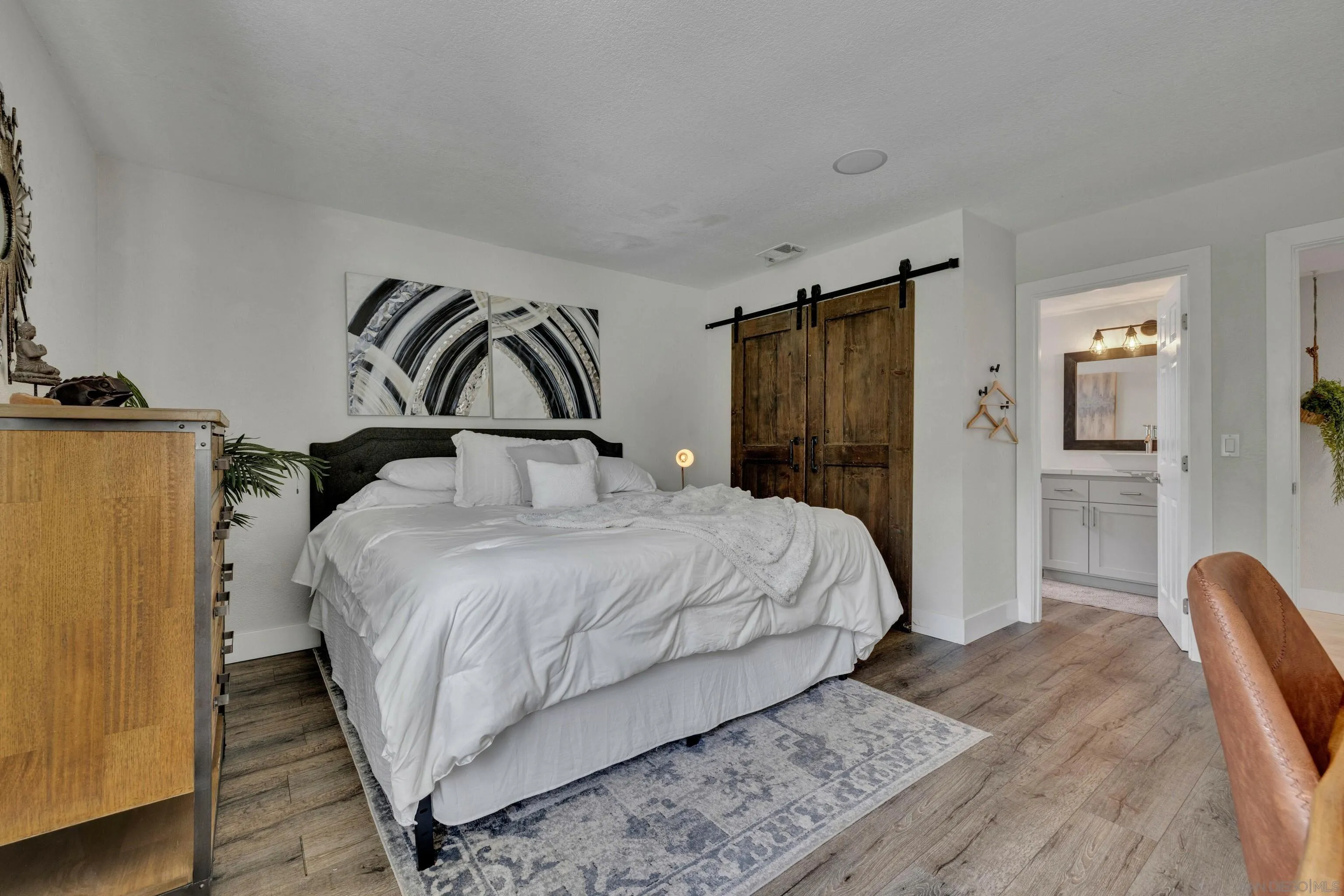 37389 Ave Chapala Temecula, CA 92592 - Photo 24 of 68 a bedroom with a bed and dresser with mirror