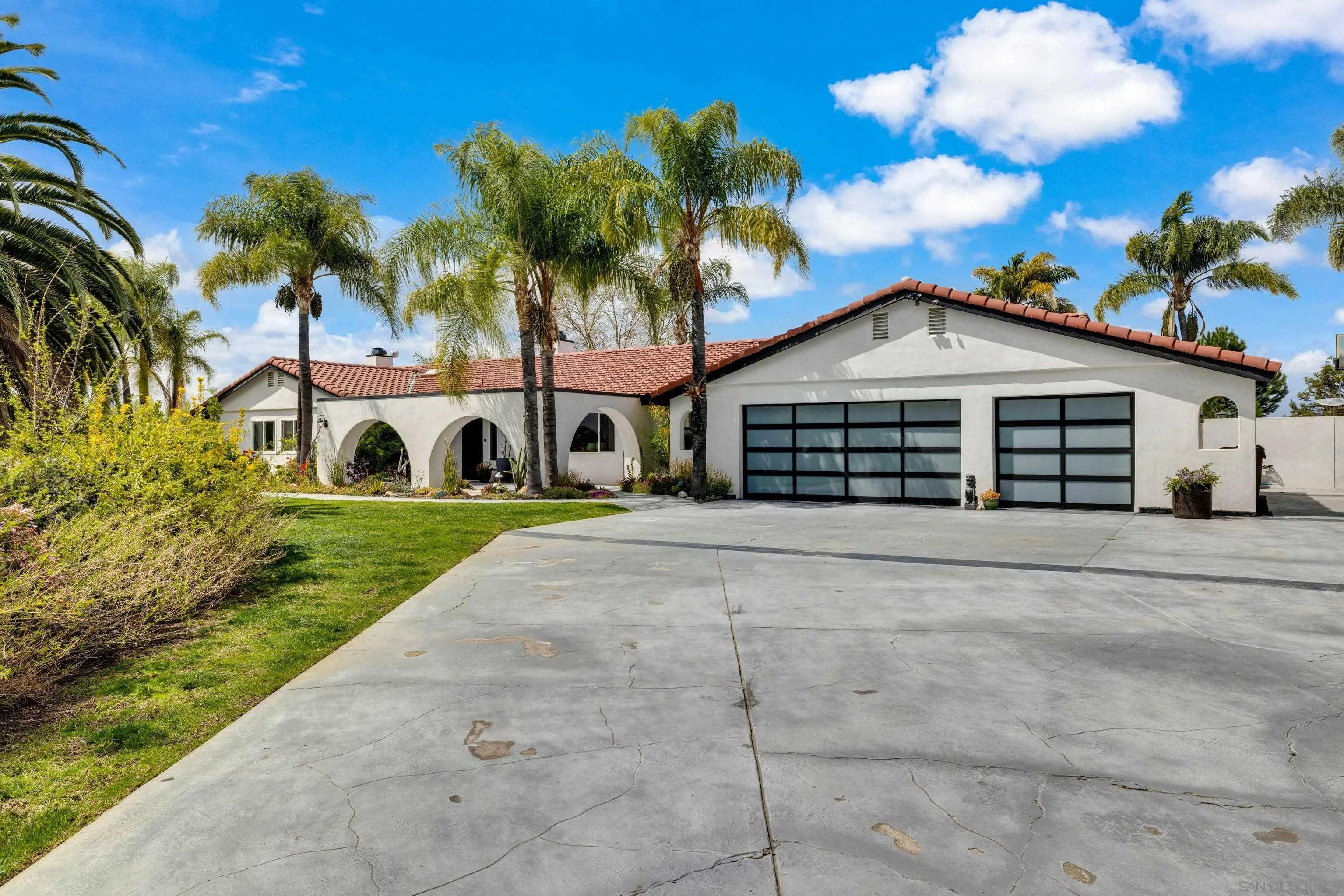 37389 Ave Chapala Temecula, CA 92592 - Photo 3 of 68 a view of a white house with a yard and palm trees
